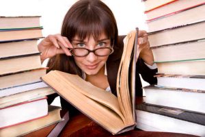 Clever girl with heap book.